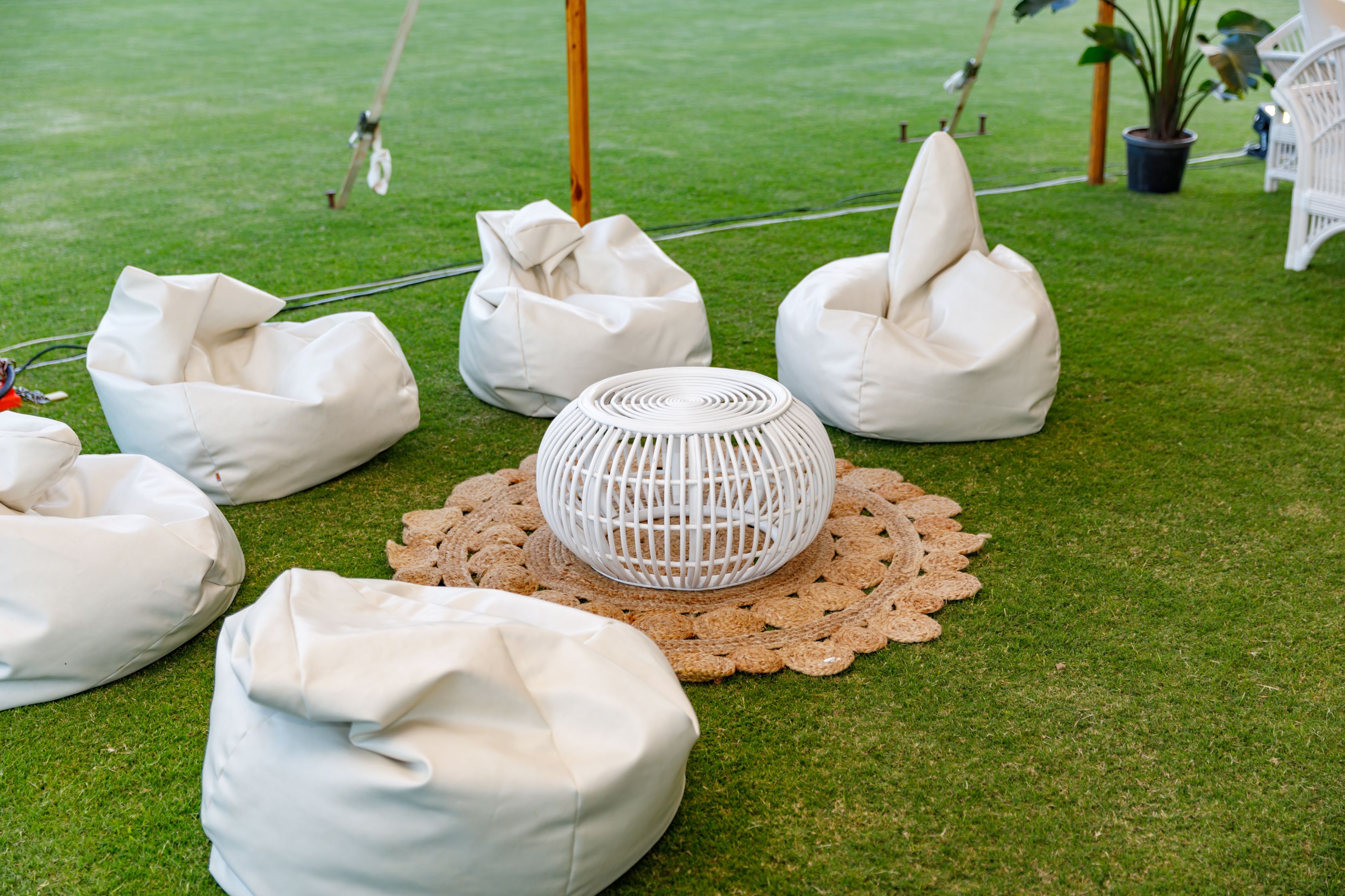 White bean bags, white bamboo table and croquet rug