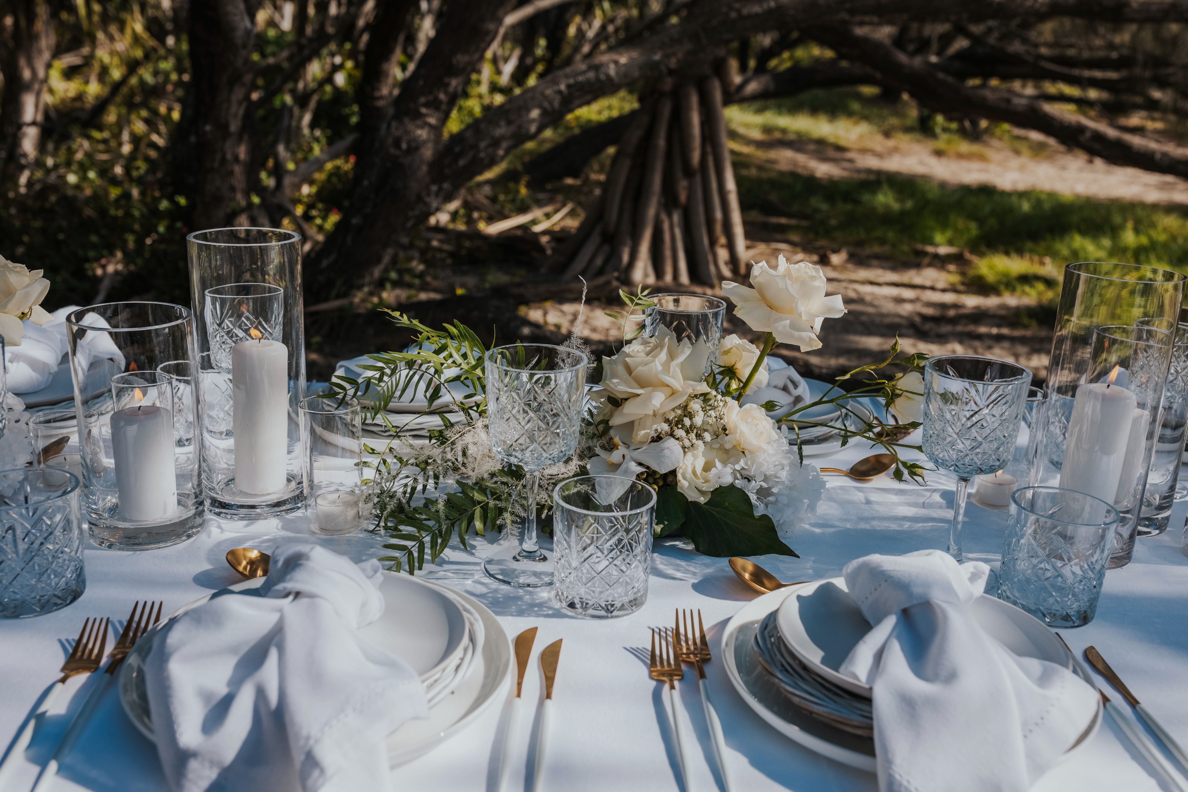 White and gold cutlery, chargers and crystal glassware