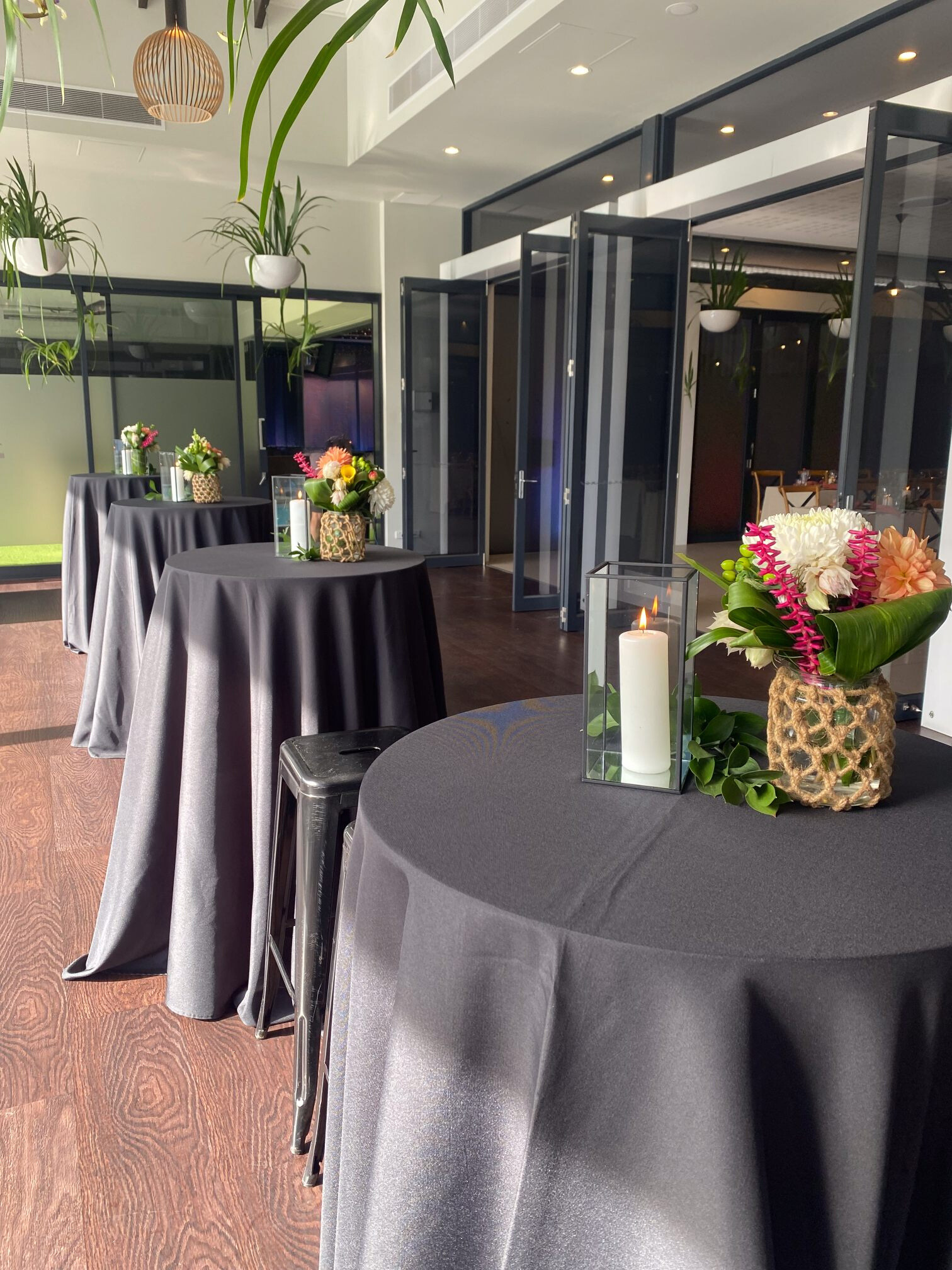 Black cocktail tables, stools and high bar centrepieces