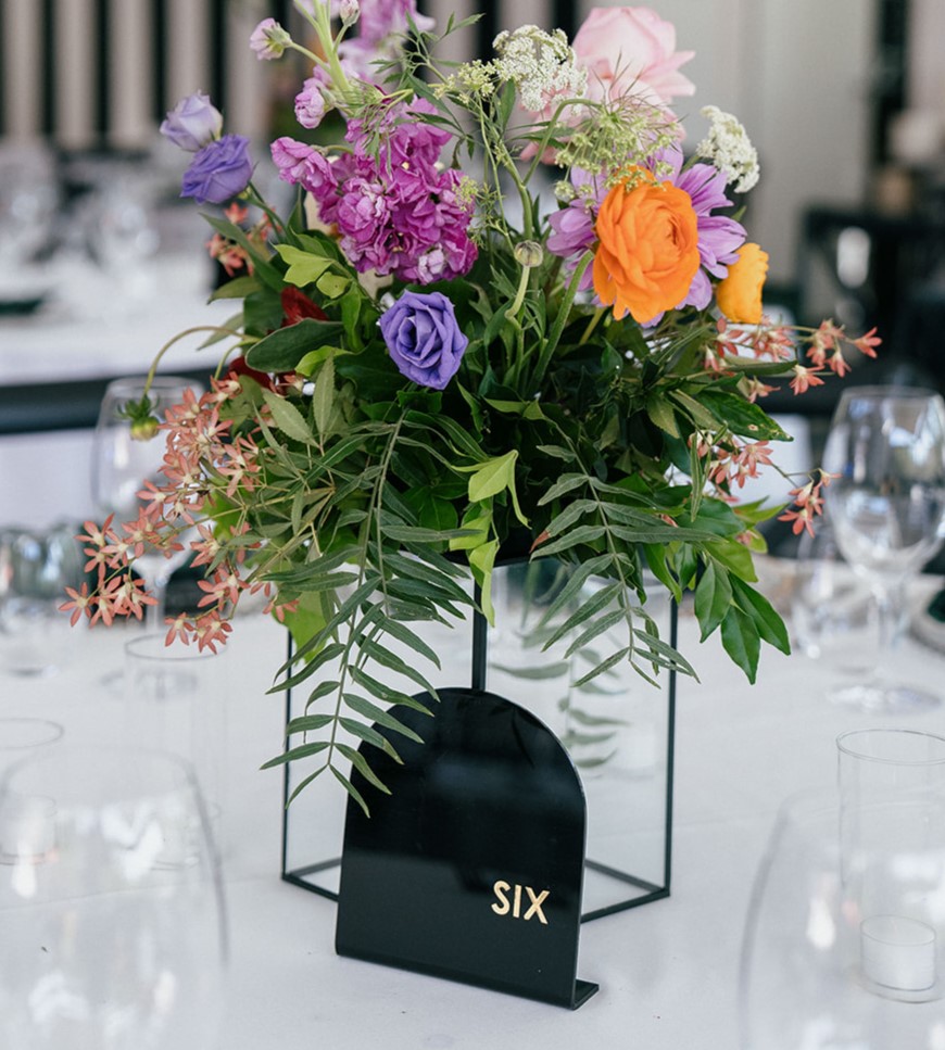 Black and gold acrylic table numbers and black frame